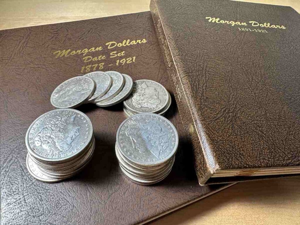 Detailed view of a Morgan Silver Dollar on top of coin books, showcasing tools for studying and valuing classic American coins