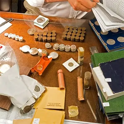 Sell Coins in Garland With Coinfully - Sell Gold Coins - Gold coins on a table for appraisal in Garland.