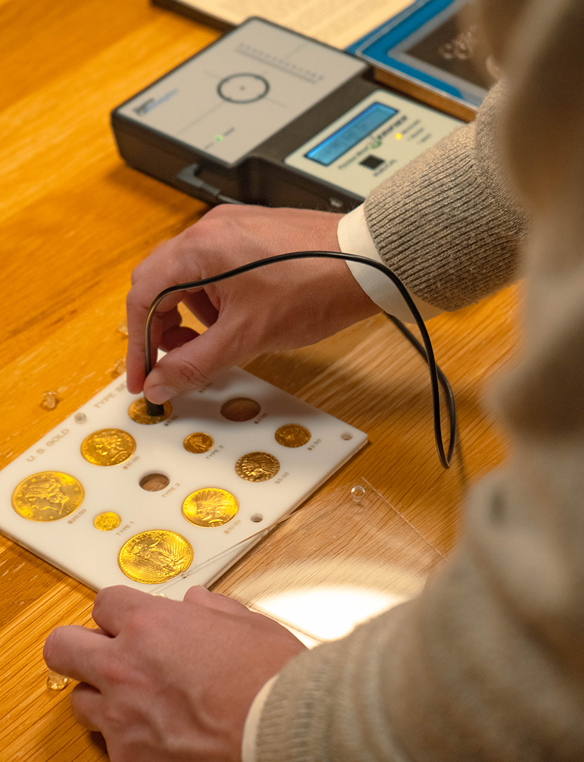 Expert authenticating gold coins