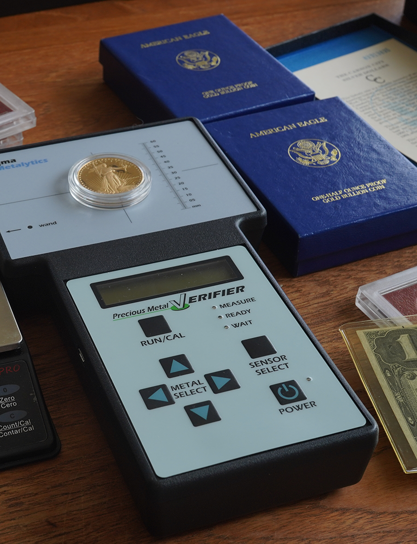 Gold Coin sitting on metal verifier