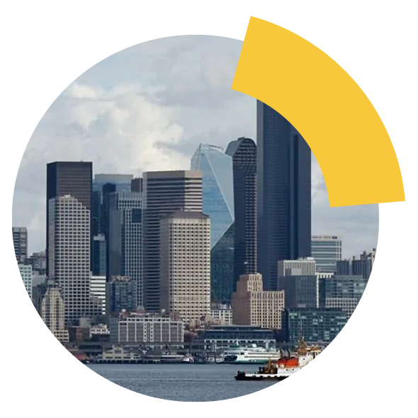 City skyline across the water with a tugboat in the foreground